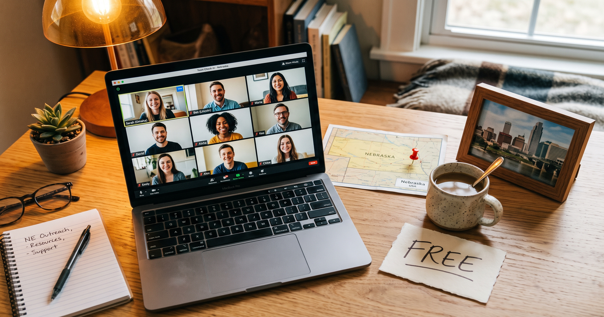 Laptop showing a Zoom recovery meeting next to a map of Nebraska with a pin and a framed photo of Omaha skyline, free AA and NA meetings across Nebraska