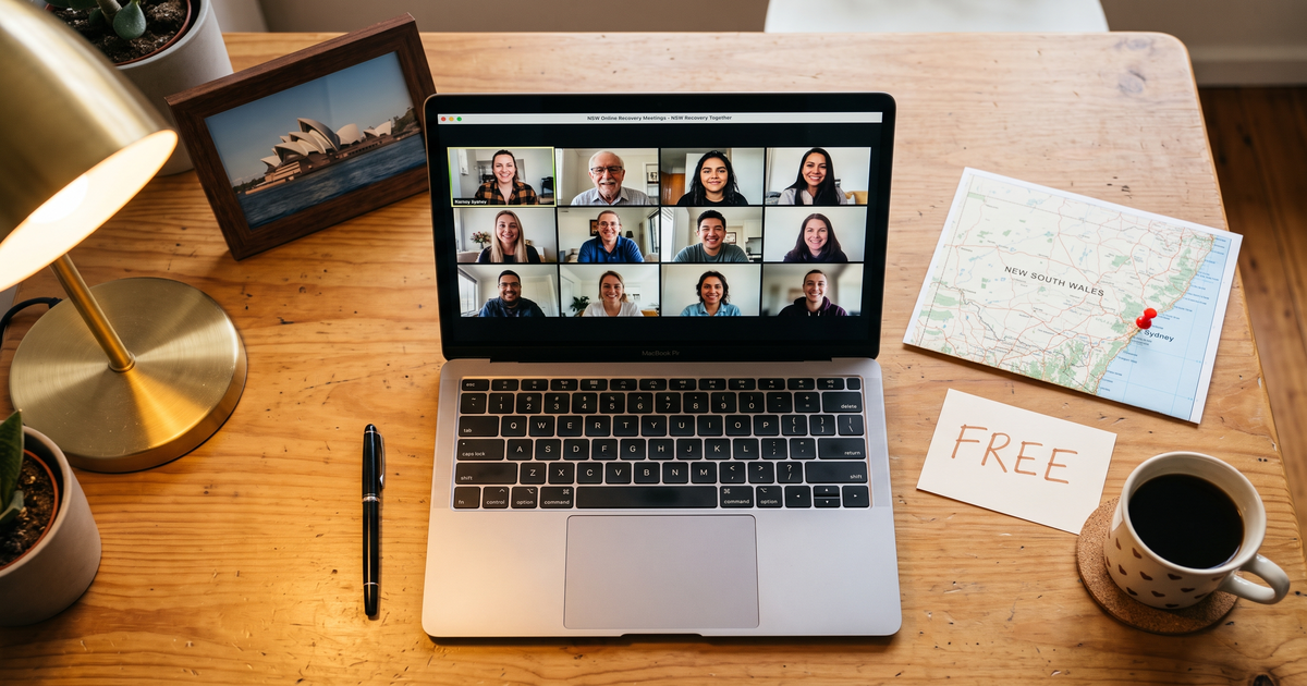 Laptop showing a Zoom recovery meeting next to a map of New South Wales with a pin on Sydney and a framed photo of the Opera House, free AA and NA meetings across NSW