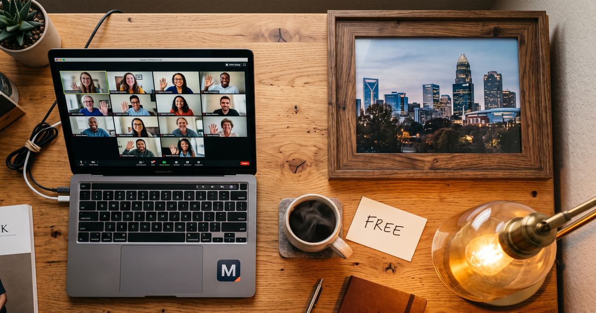 Laptop showing a Zoom recovery meeting with a framed photo of Charlotte North Carolina skyline, free AA and NA meetings in Charlotte