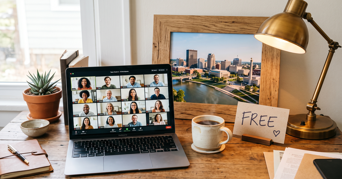 Laptop showing a Zoom recovery meeting with a framed photo of Dayton Ohio cityscape, free AA and NA meetings in Dayton